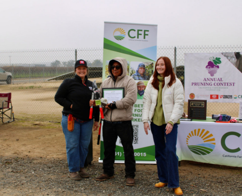 Valley Pruning Contest – California Farmworker Foundation Farmworker smiling during the Central Valley Pruning Contest held by California Farmworker Foundation