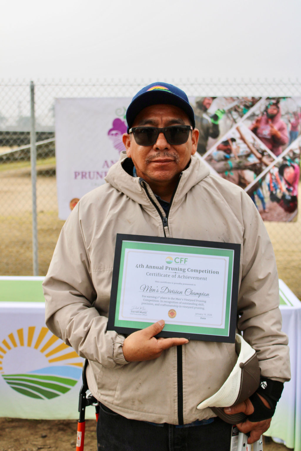 Valley Pruning Contest – California Farmworker Foundation Farmworker smiling during the Central Valley Pruning Contest held by California Farmworker Foundation