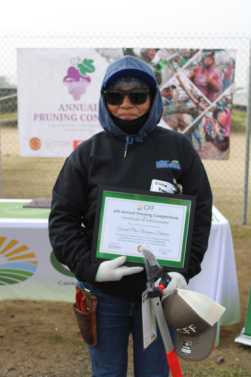 Valley Pruning Contest – California Farmworker Foundation Farmworker smiling during the Central Valley Pruning Contest held by California Farmworker Foundation