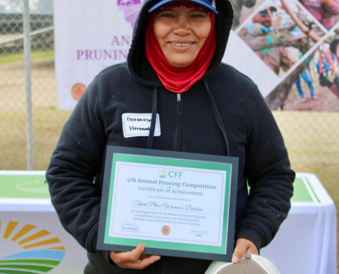 Valley Pruning Contest – California Farmworker Foundation Farmworker smiling during the Central Valley Pruning Contest held by California Farmworker Foundation
