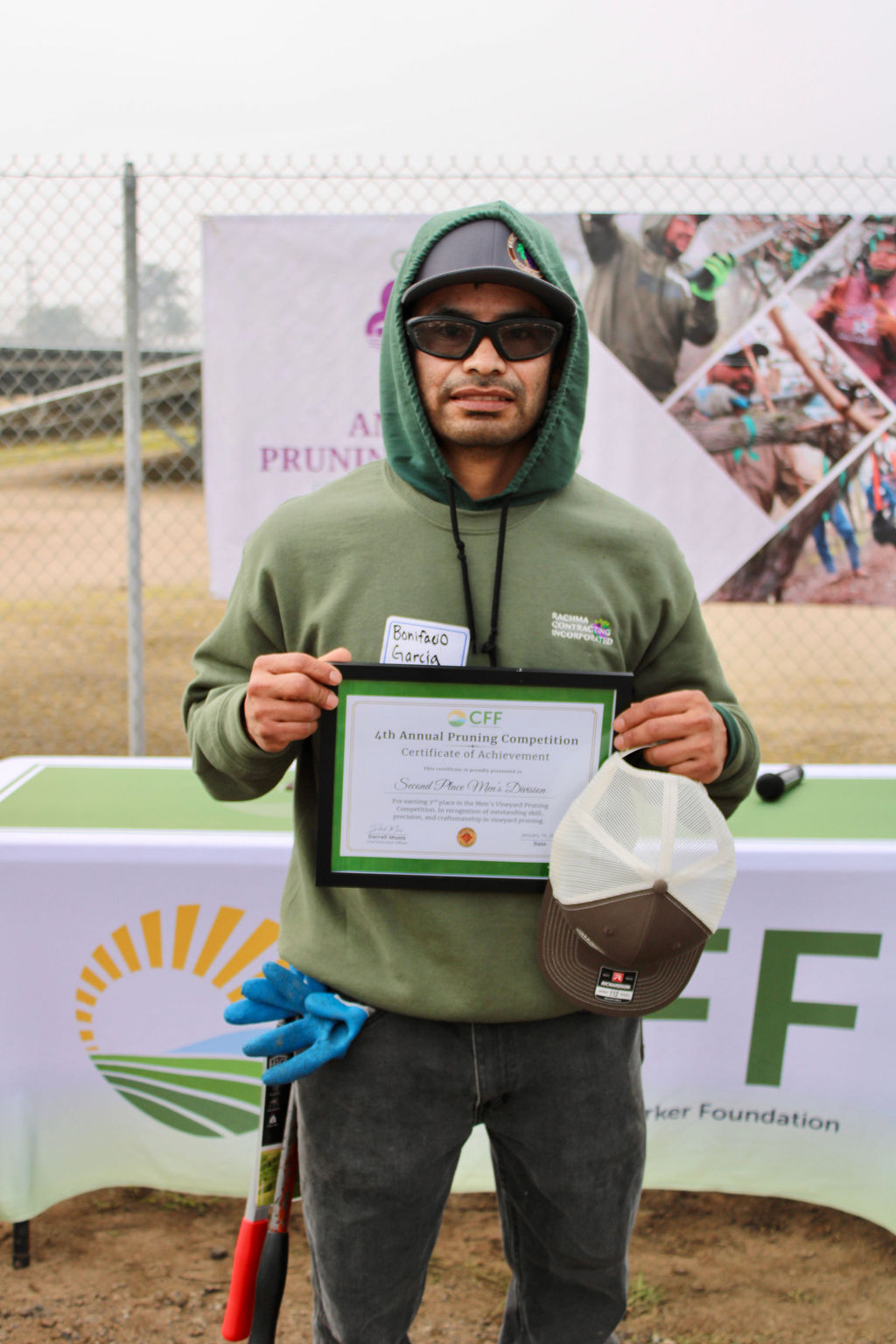 Valley Pruning Contest – California Farmworker Foundation Farmworker smiling during the Central Valley Pruning Contest held by California Farmworker Foundation