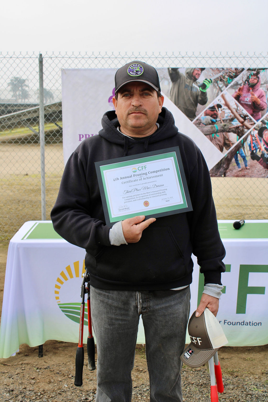 Valley Pruning Contest – California Farmworker Foundation Farmworker smiling during the Central Valley Pruning Contest held by California Farmworker Foundation